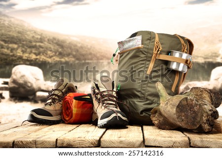 lake landscape and big backpack with shoes 