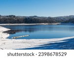 Lake Lavalette surrounded by a fir forest in the Gorges du Lignon, under the first snows of winter