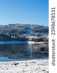 Lake Lavalette surrounded by a fir forest in the Gorges du Lignon, under the first snows of winter