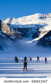 Lake Louise, January 25, 2014 - Family & Friends Play A Game Of Hockey On The Ice Amongst The Canadian Rocky Mountains At Lake Louise, Alberta, Canada