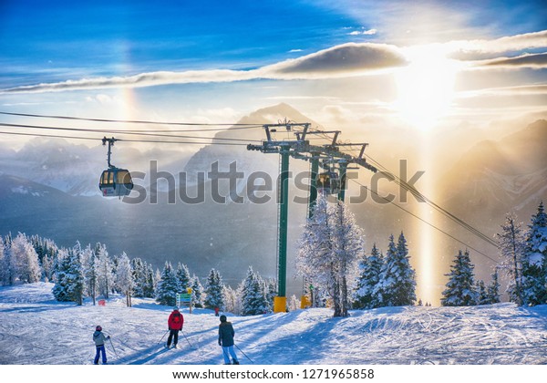 Lake Louise Ski Resort. Lake Louise. Banff.\
Alberta. Canada. Dec. 26 2018.  Skiers were admiring the sunset\
while skiing down the\
hill.