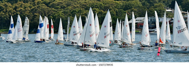 Lake Macquarie, Australia - April 17, 2013: School Children Sailing Competing In The Australian High School Championships On Belmont Bay. Race Fleet At The Starting Line.