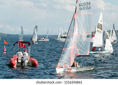 Lake Macquarie, Australia - April 18, 2013: School Children Sailing In The Australian High School Championships On Belmont Bay. The Umpire's Boat At The Starting Line.