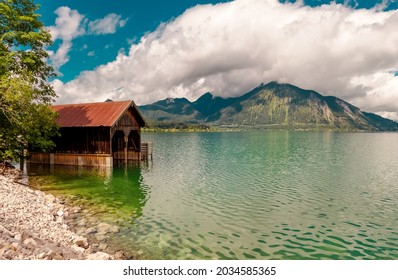 Lake in the mountains. Beautiful landscape scenery in upper Bavaria. Reflection Lake Walchensee with Boathouse at a lake. European Alps in Germany, Europe Bavarian Prealps