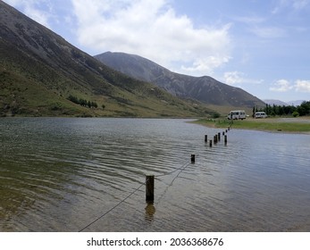 Lake With Mountains And A Submerged Fence Near Castle Hill, NZ