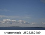 Lake Nipissing on a still, fall day with some clouds on horizon