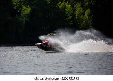 Lake Nokomis, Tomahawk, Wisconsin, USA, August, 20, 2022 - Two Girls On A Jet Ski Flying Across The Lake, Horizontal