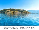 Lake Ohrid, North Macedonia, April 13 2024. Mountain range and peninsula in distance. Ohrid Lake, Macedonia, Europe. The clear mesmerizing waters of lake Ohrid with a beautiful view. 