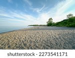 Lake Ontario in Canada. Beautiful magic wide view of sand and waves near lake water shore. Quiet peaceful and serene meditation spot. 