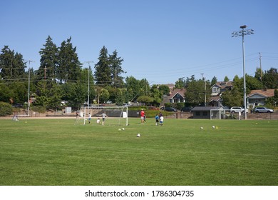 Lake Oswego, OR, USA - July 27, 2020: A Small Group Of Kids Take Part In A Summer Soccer Camp On An Athletic Field In Lake Oswego, Oregon, During The COVID-19 Crisis.