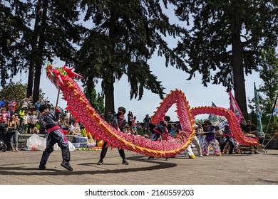 Lake Oswego, OR, USA - May 22, 2022: Dragon Dance Performed By White Lotus At The Asian American And Pacific Islander Heritage Month Celebration Held In Millennium Plaza Park In Lake Oswego, Oregon.