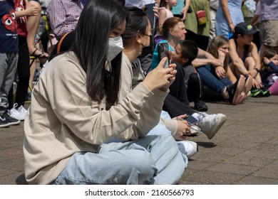 Lake Oswego, OR, USA - May 22, 2022: A Young Woman Takes A Panoramic Picture With Her IPhone At The Asian American And Pacific Islander (AAPI) Heritage Month Celebration In Lake Oswego, Oregon.