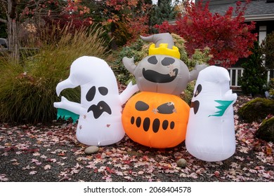 Lake Oswego, OR, USA - Oct 28, 2021: Funny Halloween Inflatables Are Seen In A Front Yard With Colorful Fall Foliage And Fallen Leaves In Lake Oswego, Oregon, During The Holiday Season.