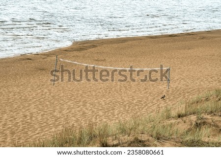 Lake Peipus beach and volleyball net. A deserted beach at the end of the season and a volleyball net on the coast.