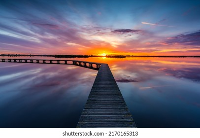 Lake pier at dawn landscape. Lake pier at dawn. Beautiful sunrise over lake pier. Lake pier at dawn landscape - Shutterstock ID 2170165313