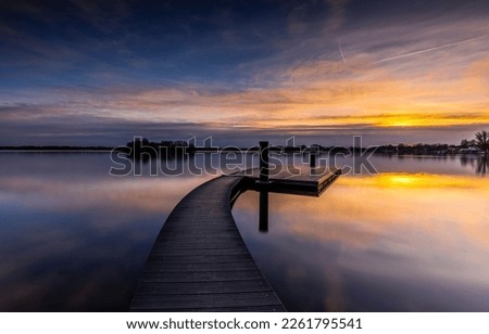 Lake pier in the morning at dawn. Lake pier at dawn. Sunrise over lake pier. Lake pier at dawn landscape