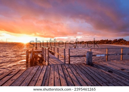 Lake pier in Poole Dorset at sunset with dramatic sky