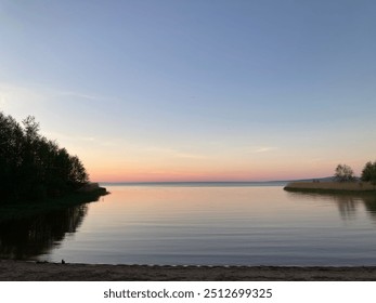 Lake in pink sunset with sandy beach. - Powered by Shutterstock