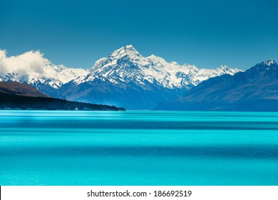  Lake Pukaki view from Glentanner Park Centre near Mount Cook, on a background of blue sky with clouds, snowy Southern Alps. 