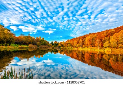 Lake reflecting sky in autumn landscape
