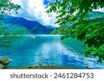 Lake Ritsa panoramic summer view. Beautiful summer nature landscape of Lake Ritsa in Abkhazia. Caucasus Mountains and blue Ritsa lake waters background wallpaper.