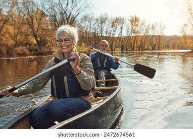 Lake, rowing and kayak with old couple, nature and retirement with happiness, relax and vacation. Outdoor, river and mature man with senior woman, freedom and trust with holiday and weekend break