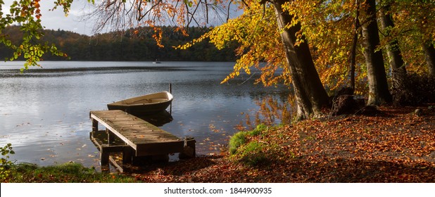 Lake Scenery With Jetty And Row Boat In Beautiful Autumn Colors