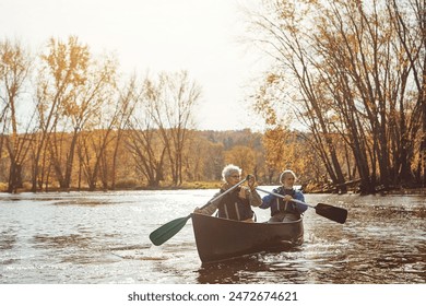 Lake, senior couple and kayaking in nature with canoe for explore, adventure or retirement activity. Outdoor, river and elderly woman with man on boat for rowing, holiday or weekend break in Sydney - Powered by Shutterstock