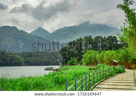 lake serene with beautiful hiking trails and mountain background image is taken at banasura sagar dam wayanad kerala india. the natural beauty of this place is amazing.