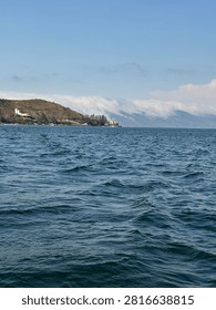 Lake Sevan viewed from a boat in Armenia

Scenic view of Lake Sevan in Armenia, photographed from a boat, featuring clear blue water, surrounding mountains and peaceful natural landscape on a sunny day.
