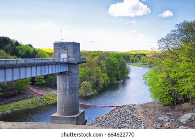 The Lake Side Of Hop Brook Dam In Naugatuck Connecticut On A Sunny Blue Sky Day.