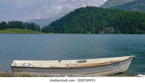 Lake Side View In The Mountains With A Small Boat