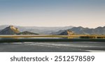 Lake Skadar at sunrise. View of the northern bank - Dinaric Alps in first rays of sun and gradient sky in the background. Lake is partially covered with floating plants.