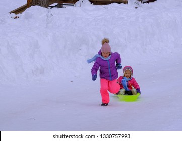 Lake Tahoe, California / USA - 02/24/2019: Kids Playing Sledge Around Pope Beach Near Tahoe Keys Rental Home In Winter