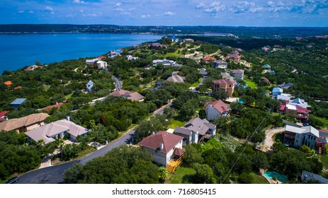 Lake Travis mansions and homes along the lake aerial drone view colorful rooftops in a nice wealthy Community Neighborhood overlooking the Lake