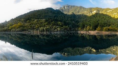 Lake Tsivlou (Achaia, Greece). Beautiful reflections on the water. A famous destination for camping, trails, picnic or water activities. Panoramic view