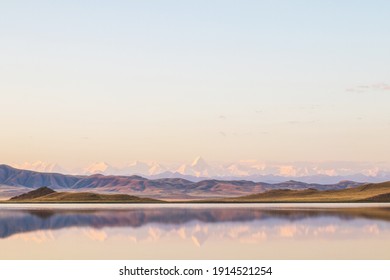 Lake Tuzkol in Kazakhstan and a view of Khan Tengri peak at sunrise in summer - Shutterstock ID 1914521254