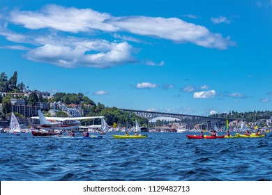 Lake Union, Seattle, WA - July 7, 2018: Sea Plane Taking Off Between Group Of Kayakers