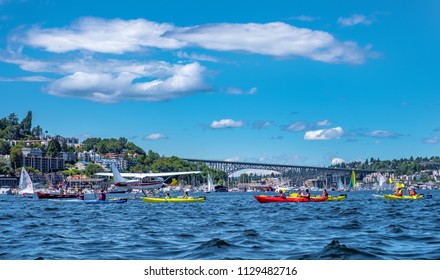 Lake Union, Seattle, WA - July 7, 2018: Sea Plane Taking Off Between Group Of Kayakers