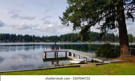 Lake View With Port And Evergreen Tree From Backyard In Sunset. Image In Soft Focus And Less Light.