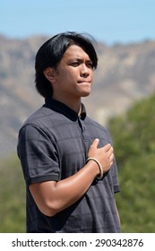 LAKE VIEW TERRACE, CA â?? JUNE 20, 2015: A Young Man Born In The Philippines Holds His Hand On His Heart, Takng An Oath Before Becoming A U.S. Citizen During A Public Ceremony On June 20, 2015.
