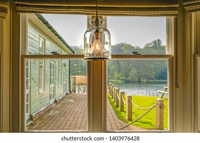 a lake view through a window frame with a light bulb