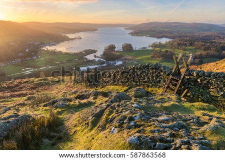 Lake Windermere in the English Lake District taken at sunrise with vibrant colours and golden morning light.