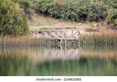 Lake Wooden Dock With Reflections