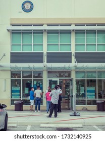 Lake Worth, Fl USA 05/15/2020 Exterior Of The Palm Beach County Tax Collectors And DMV With Guards And Masked Customers Waiting To Enter