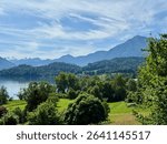 Lake Zug near Risch on a beautiful sunny spring day with the snow-covered Alps in the background