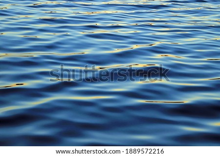 A lakes surface with light reflecting.