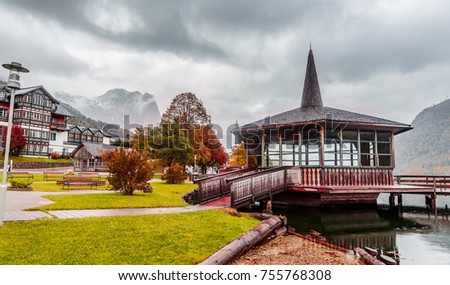 The lakeshore promenade in Grundlsee and of the Mountain Backenstein on background. with dramatic sky. villas and hotels On the lakeside. Grundlsee, Salzkammergut, Styria, Austria