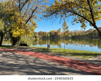 Lakeside Bike Lane with a bench in Autumn Park - Powered by Shutterstock