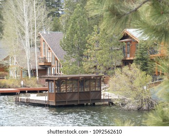 Lakeside House In The Forest On The Bank Of A Lake With Out Buildings, Northern California Sierra Mountains, USA.